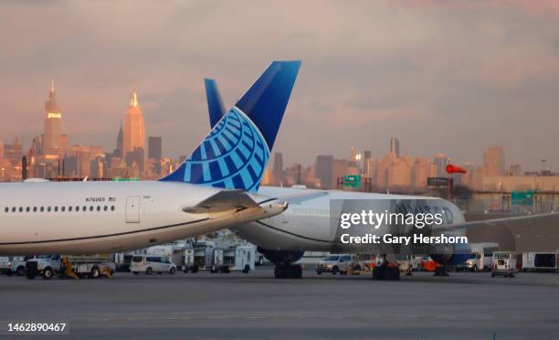 United Airlines airplanes sit on the tarmac at Newark Liberty Airport in front of the Empire State Building in New York City on February 3 in Newark,...