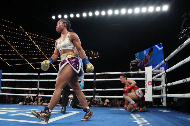 Alycia Baumgardner knocks down Elhem Mekhaled, during their fight for Baumgardner's WBC, WBO and IBF junior lightweight titles and the vacant WBA...