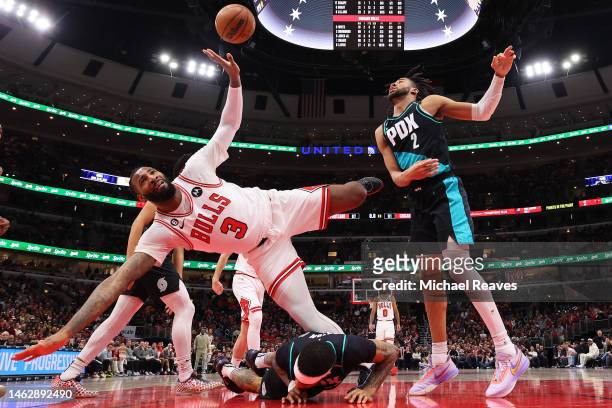 Andre Drummond of the Chicago Bulls trips over Gary Payton II of the Portland Trail Blazers during the second half at United Center on February 04,...