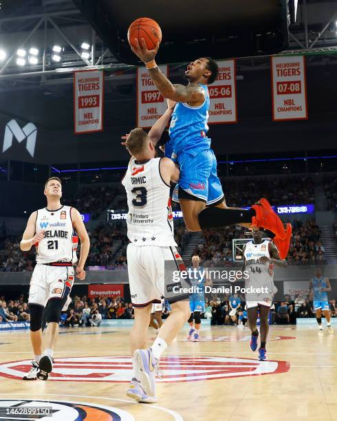 Rayjon Tucker of United drives to the basket under pressure from Anthony Drmic of the 36ers during the round 18 NBL match between Melbourne United...