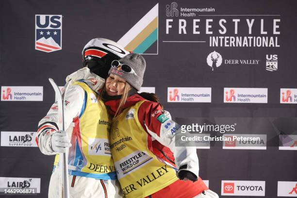 New season points leaders Mikael Kingsbury of Team Canada and Anri Kawamura of Team Japan embrace on the podium following the Men's and Women's Dual...