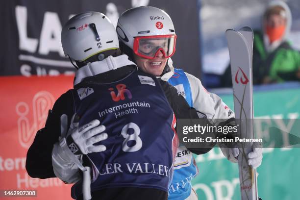 Mikael Kingsbury of Team Canada embraces Matt Graham of Team Australia after their championship match in the Men's Dual Moguls Finals on day three of...