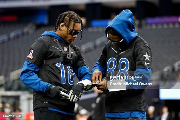 Wide receiver Justin Jefferson of the Minnesota Vikings and NFC wide receiver CeeDee Lamb of the Dallas Cowboys look at their play sheet during a...