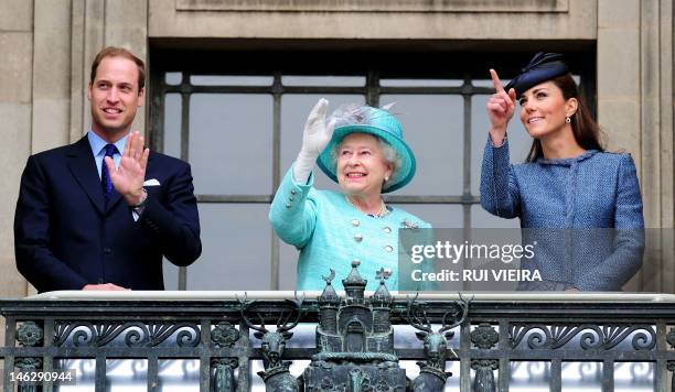 Britain's Queen Elizabeth II , Prince William and Catherine, Duchess of Cambridge wave from the balcony of Council House in Nottingham, central...