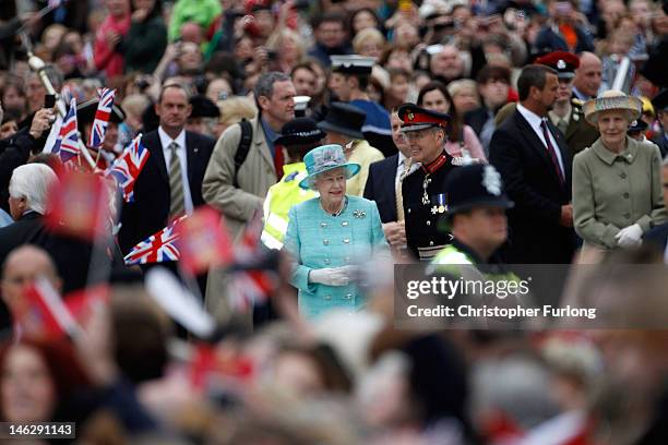 Queen Elizabeth II smiles as she greets the crowds at Nottingham Town Hall during her visit to the East Midlands on June 13, 2012 in Nottingham,...