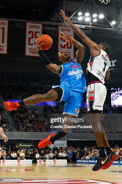 Rayjon Tucker of United drives to the basket under pressure from Antonius Cleveland of the 36ers during the round 18 NBL match between Melbourne...