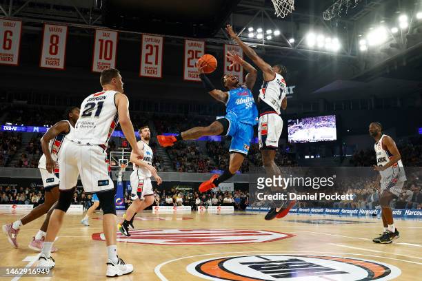 Rayjon Tucker of United drives to the basket under pressure from Antonius Cleveland of the 36ers during the round 18 NBL match between Melbourne...