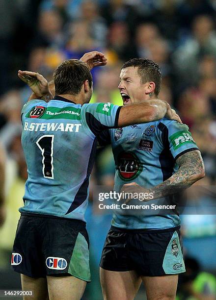 Todd Carney of the Blues celebrates with team mate Brett Stewart after winning game two of the ARL State of Origin series between the New South Wales...