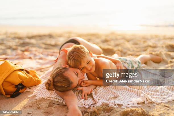 mother and son at the beach - family city break stock pictures, royalty-free photos & images