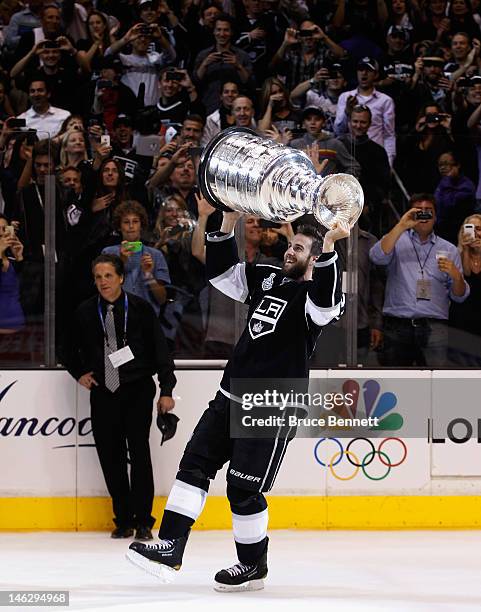 Simon Gagne of the Los Angeles Kings holds up the Stanley Cup after the Kings defeated the New Jersey Devils 6-1 to win the Stanley Cup series 4-2 in...