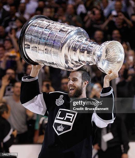 Simon Gagne of the Los Angeles Kings holds up the Stanley Cup after the Kings defeated the New Jersey Devils 6-1 to win the Stanley Cup series 4-2 in...