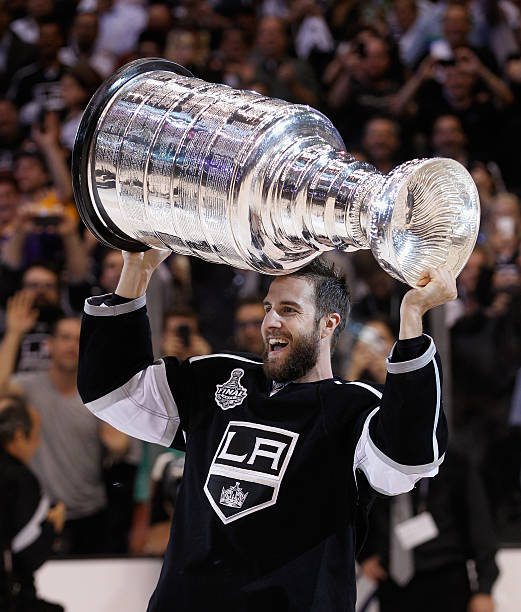 simon-gagne-of-the-los-angeles-kings-holds-up-the-stanley-cup-after-the-kings-defeated-the-new.jpg