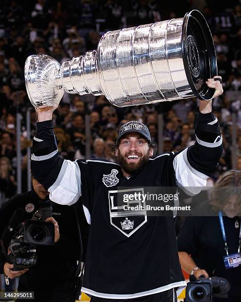 Jarrett Stoll of the Los Angeles Kings holds up the Stanley Cup after the Kings defeated the New Jersey Devils 6-1 to win the Stanley Cup series 4-2...