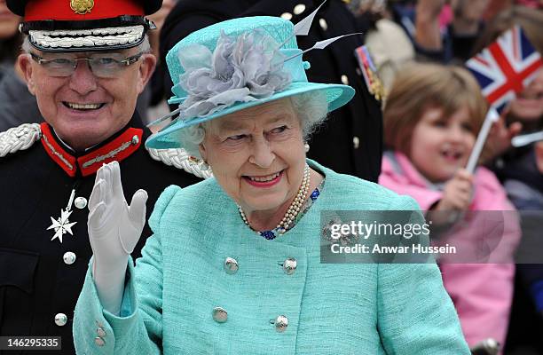 Queen Elizabeth ll waves to the public in the Market Square during a Diamond Jubilee visit to Nottingham on June 13, 2012 in Nottingham, England.