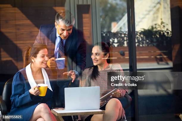 happy business people drinking coffee and using laptop - india business meeting stock pictures, royalty-free photos & images