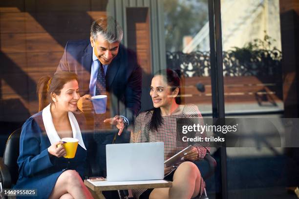 happy business people drinking coffee and using laptop - indian colleague stock pictures, royalty-free photos & images