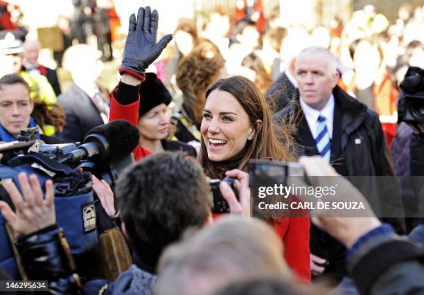 Kate Middleton, fiancee of Britain's Prince William, waves to members of the public during a visit to the University of St Andrews in Scotland, on...