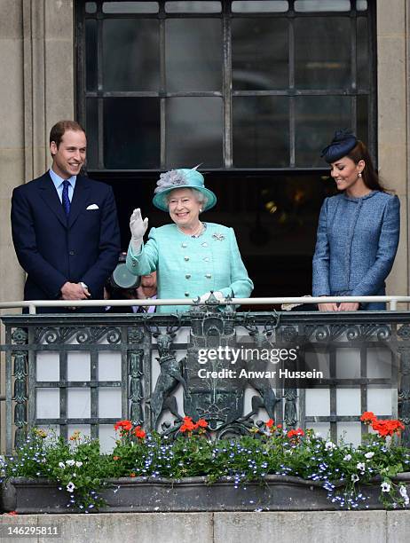 Queen Elizabeth ll waves beside Prince William, Duke of Cambridge and Catherine, Duchess of Cambridge on the balcony of the Council House in the...