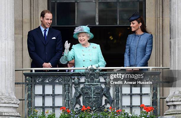 Queen Elizabeth ll waves beside Prince William, Duke of Cambridge and Catherine, Duchess of Cambridge on the balcony of the Council House in the...