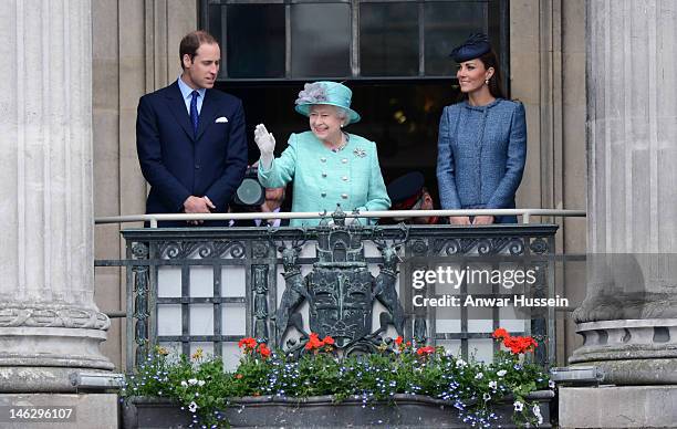 Queen Elizabeth ll waves beside Prince William, Duke of Cambridge and Catherine, Duchess of Cambridge on the balcony of the Council House in the...