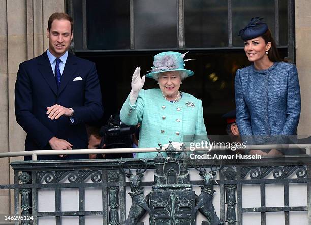 Queen Elizabeth ll waves beside Prince William, Duke of Cambridge and Catherine, Duchess of Cambridge on the balcony of the Council House in the...