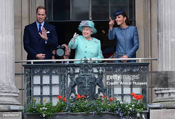 Queen Elizabeth ll, Prince William, Duke of Cambridge and Catherine, Duchess of Cambridge stand on the balcony of the Council House in the Market...