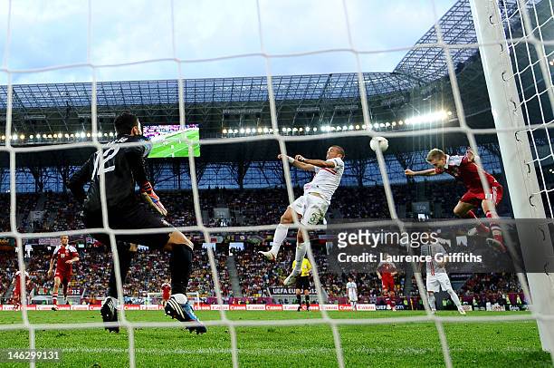 Nicklas Bendtner of Denmark beats Pepe of Portugal to head in their second goal during the UEFA EURO 2012 group B match between Denmark and Portugal...