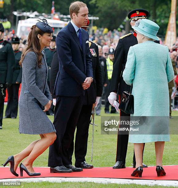 Catherine, Duchess of Cambridge curtsies as her and her husband Prince William, Duke of Cambridge bid farewell to Queen Elizabeth II after visiting...