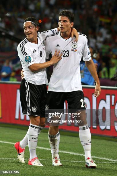 Mario Gomez of Germany celebrates scoring their second goal with Mesut Ozil of Germany during the UEFA EURO 2012 group B match between Netherlands...