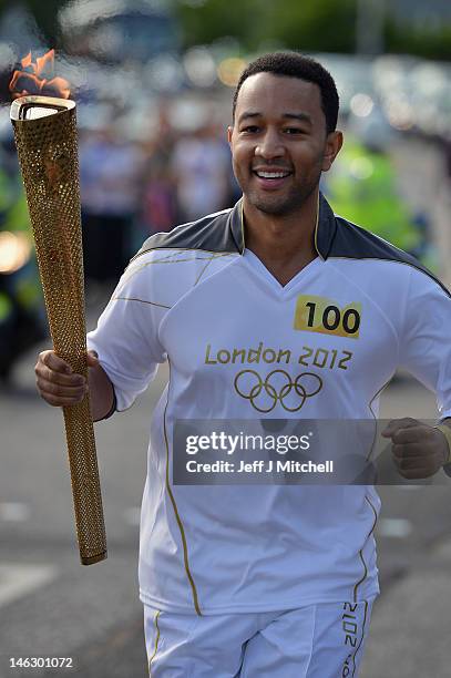 Singer songwriter John Legend carries the Olympic Torch during the London 2012 Olympic Torch Relay on June 2012 in Edinburgh, Scotland. The Olympic...