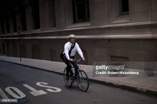 Man bicycles to work near Wall Street and the New York Stock Exchange, June 5, 2012 in New York City.