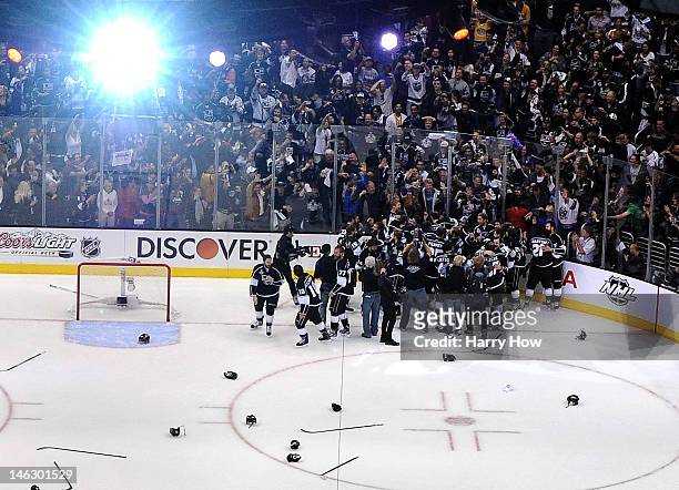 Players of the Los Angeles Kings leave the bench and celebrate with goaltender Jonathan Quick of the Los Angeles Kings after winning Game Six of the...