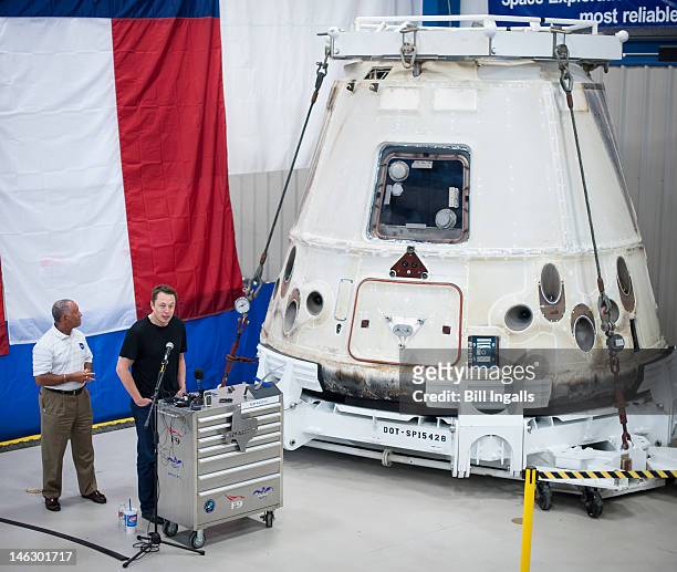 In this handout from NASA, SpaceX CEO and Chief Designer Elon Musk speaks as NASA Administrator Charles Bolden, listens next to the Dragon capsule at...