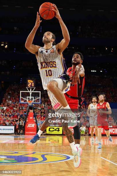 Xavier Cooks of the Kings goes to the basket against Corey Webster of the Wildcats during the round 18 NBL match between Perth Wildcats and Sydney...