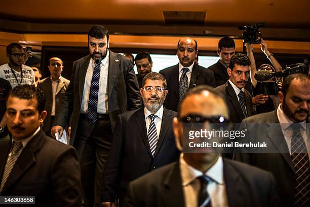 Egyptian presidential candidate Mohamed Morsi of the Muslim Brotherhood arrives to speak at a press conference on June 13, 2012 in Cairo, Egypt....