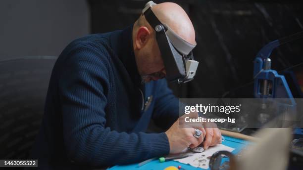watchmaker fixing watch in his work place - small clock stock pictures, royalty-free photos & images