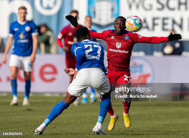 Jean-Luc Dompe of Hamburger SV is challenged by Frederic Ananou of F.C. Hansa Rostock during the Second Bundesliga match between F.C. Hansa Rostock...