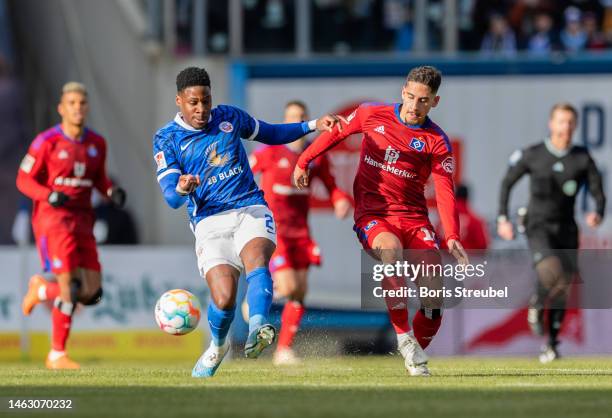 Frederic Ananou of F.C. Hansa Rostock is challenged by Ludovit Reis of Hamburger SV during the Second Bundesliga match between F.C. Hansa Rostock and...