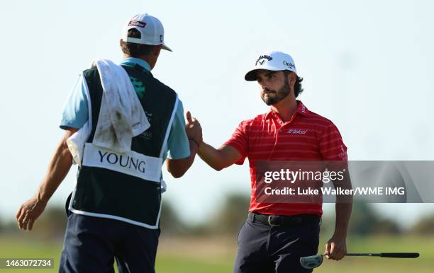 Abraham Ancer of Mexico celebrates with his caddie on the 18th green after winning the PIF Saudi International at Royal Greens Golf & Country Club on...