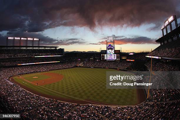 The sun sets over right field as the Oakland Athletics face the Colorado Rockies during Interleague Play at Coors Field on June 13, 2012 in Denver,...