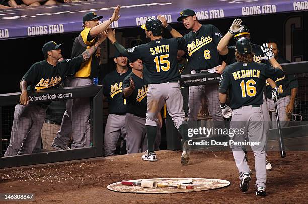 The Oakland Athletics celebrate as Seth Smith of the Oakland Athletics and Josh Reddick of the Oakland Athletics scored on the game winning two RBI...