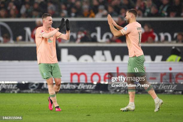 Marvin Ducksch of SV Werder Bremen celebrates with teammate Niclas Fuellkrug after scoring the team's second goal during the Bundesliga match between...