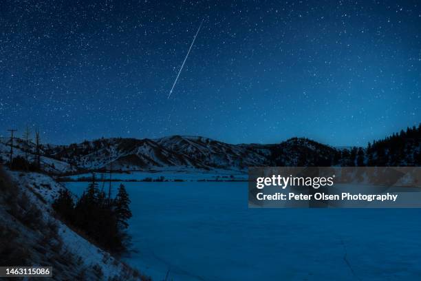 shooting star over frozen lake in kamloops bc - star trails stock pictures, royalty-free photos & images