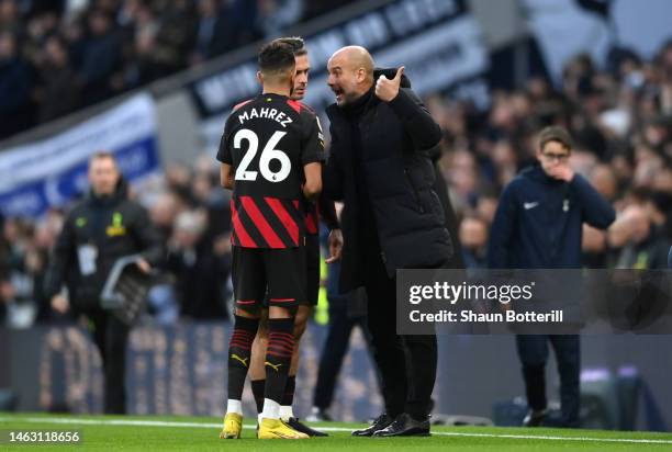 Pep Guardiola speaks to Jack Grealish and Riyad Mahrez of Manchester City prior to the Premier League match between Tottenham Hotspur and Manchester...