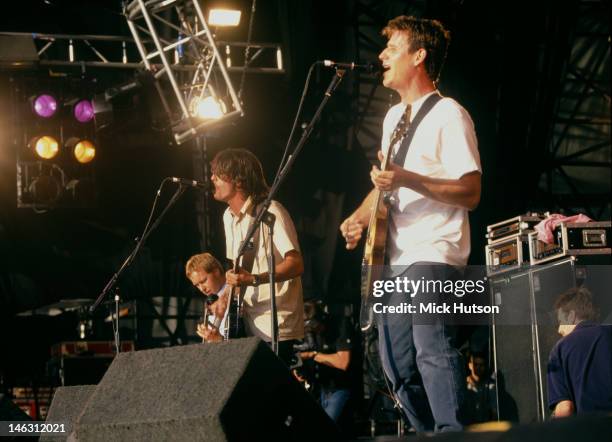 American alternative rock group Foo Fighters, performing on stage, 1998. Left to right: Nate Mendel, Dave Grohl and Franz Stahl.