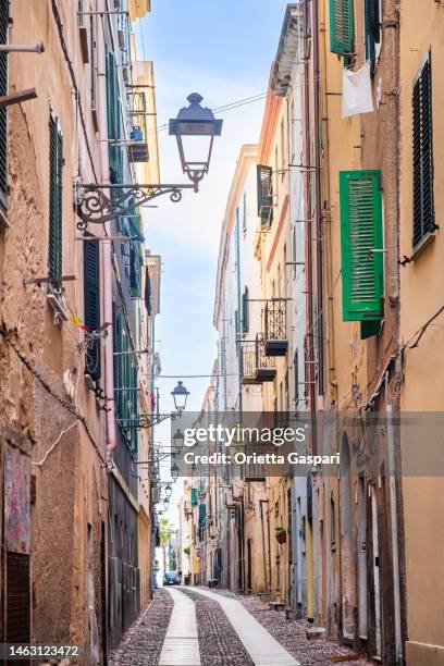 alley in the old town of alghero, a travel destination in sardinia - alghero stock pictures, royalty-free photos & images