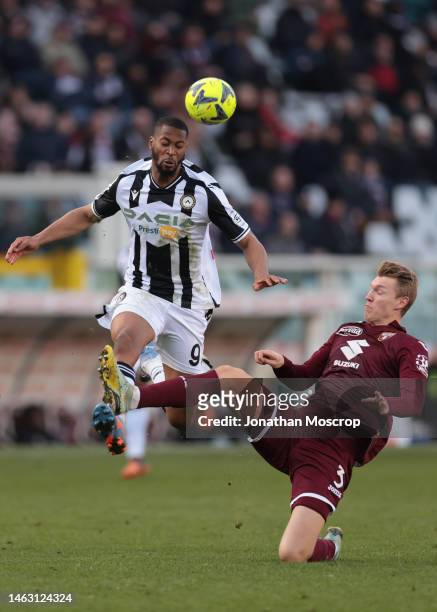 Perr Schuurs of Torino FC stretches to clear the ball from Beto of Udinese Calcio during the Serie A match between Torino FC and Udinese Calcio at...