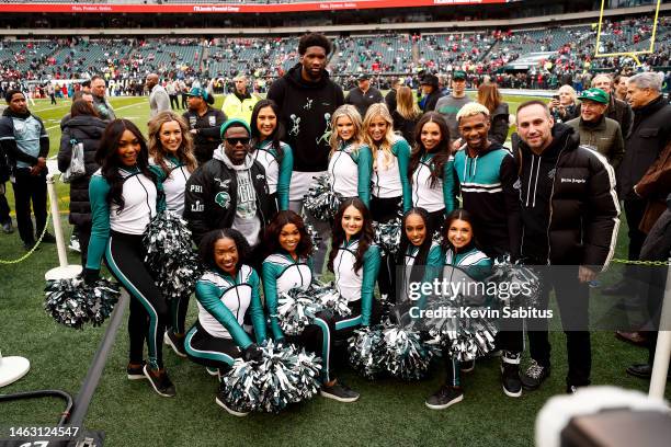 Joel Embiid of the Philadelphia 76ers, comedian Kevin Hart, and Executive Chairman of Fanatics Michael Rubin pose for a photo with the Philadelphia...