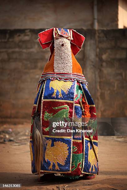 An 'Egungun' spirit stands during a Voodoo ceremony on January 09, 2012 in Ouidah, Benin. The Egungun are masqueraded dancers that represents the...