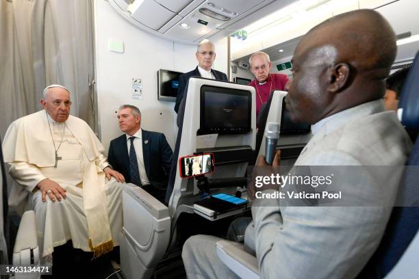 Pope Francis, the Archbishop of Canterbury Justin Welby and Rev. Iain Greenshields meet journalists on February 05, 2023 on the papal flight return...